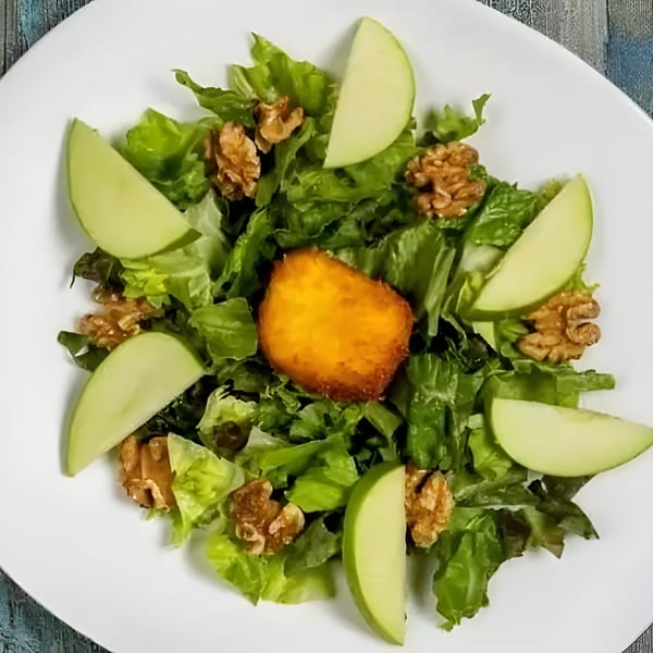 Sage Restaurant's fresh green salad with apple slices, walnuts, and a golden-brown fried cheese.