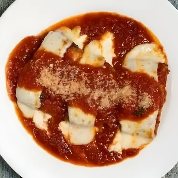 Sage Restaurant's Italian lasagna, topped with rich red sauce, melted cheese, and grated Parmesan.