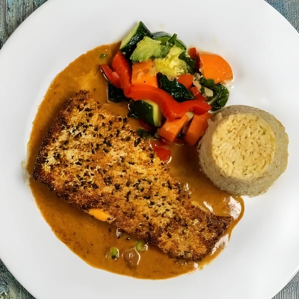 Sage Restaurant's Italian dish with crispy bread, vegetables, and a side of polenta in sauce.